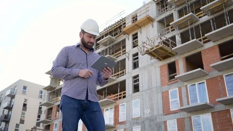 Architect browsing tablet at building place. Slider shot left. 库存影片 70804718