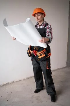 Architect builder with paper project plan of rooms, civil engineer working wi Stock Photos