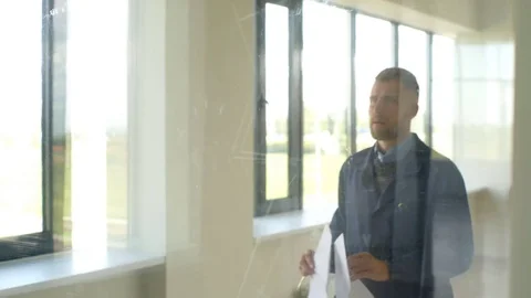 Architect builder studying layout plan of the rooms, serious civil engineer Stock Footage 70797680