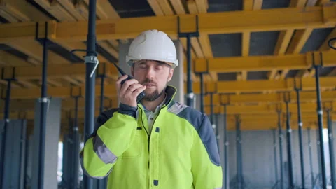 Architect Builder talking on the radio building under construction. Engineer in Video stock 113120769