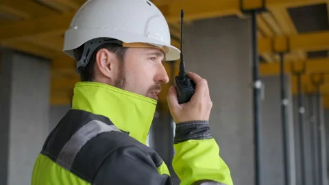 Architect Builder talking on the radio building under construction. Engineer in Video stock 113120773