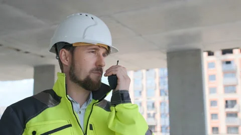 Architect Builder talking on the radio building under construction. Engineer in Video stock 113120866