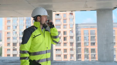 Architect Builder talking on the radio building under construction. Engineer in Video stock 113120892