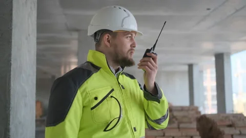 Architect Builder talking on the radio building under construction. Engineer in Stock Footage 113350057