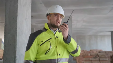 Architect Builder talking on the radio building under construction. Engineer in Stock Footage 113350471