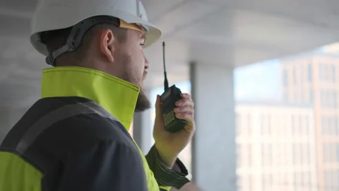 Architect Builder talking on the radio building under construction. Engineer in Stock Footage 113350899