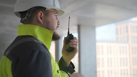 Architect Builder talking on the radio building under construction. Engineer in Stock Footage 113350901