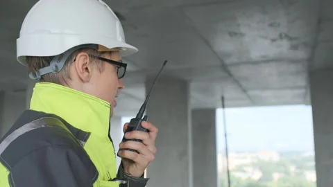 Architect Builder talking on the radio building under construction. Engineer in Stock Footage 113353938
