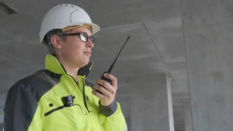 Architect Builder talking on the radio building under construction. Engineer in Stock Footage 113353941