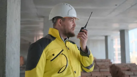 Architect Builder talking on the radio building under construction. Engineer in Video stock 114532938