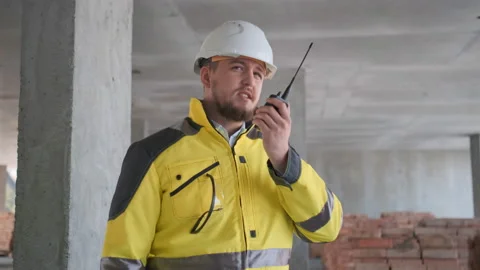 Architect Builder talking on the radio building under construction. Engineer in Video stock 114533157