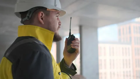 Architect Builder talking on the radio building under construction. Engineer in Video stock 114533306