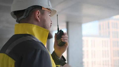 Architect Builder talking on the radio building under construction. Engineer in Video stock 114533473