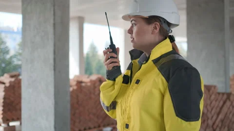 Architect Builder talking on the radio building under construction. Engineer in Video stock 114536839