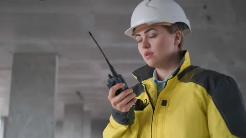 Architect Builder talking on the radio building under construction. Engineer in Stock Footage 114537448