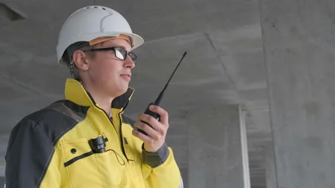 Architect Builder talking on the radio building under construction. Engineer in Stock Footage 114540401