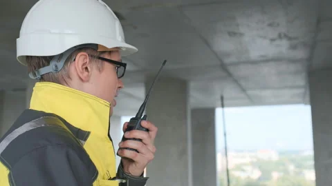 Architect Builder talking on the radio building under construction. Engineer in Stock Footage 114540450