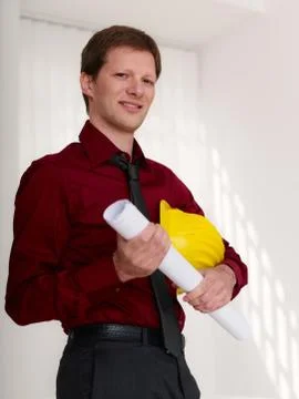 Architect with building plans smiling at camera Stock Photos