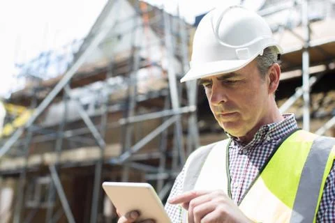 Architect On Building Site Using Digital Tablet Stock Photos