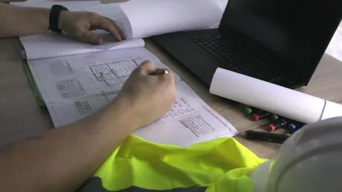 The architect carefully examines the blueprints Stock Footage 300369631