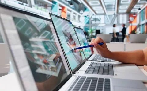 Architect Carefully Studies 3D Building Model On Laptop, Planning Constructio Stock Photos