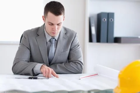 Architect checking building plan Fotos de archivo