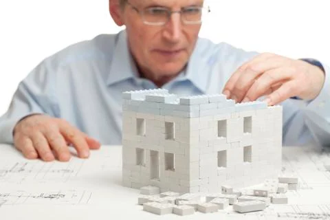 Architect constructing a house - white background Фото