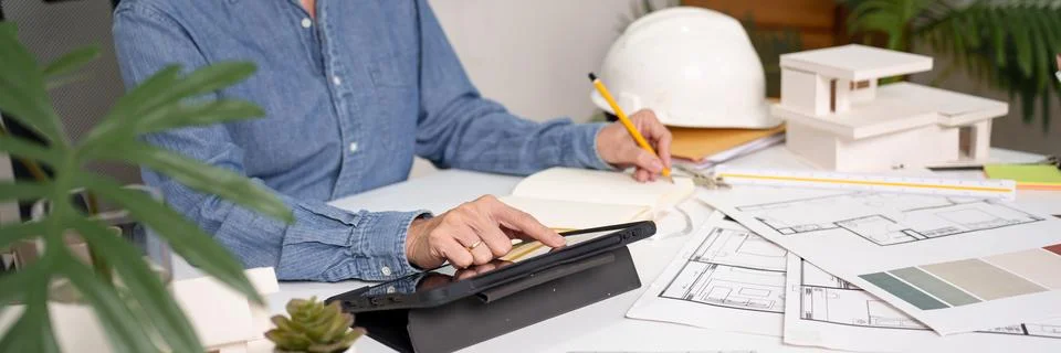 Architect Design Blueprint Plans Using Tablet for Home Renovation Interior .. Stock Photos