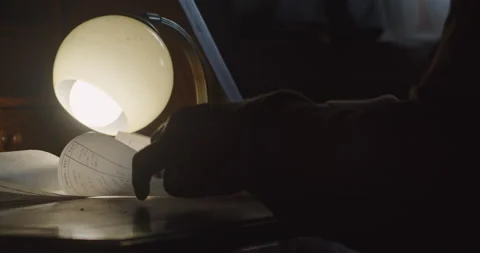 Architect , designer looking over a roll of design plans in the early evening. Stock Footage 211726281