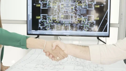 Architect, designer or engineers shaking hand in the office slow motion Stock Footage 99989307