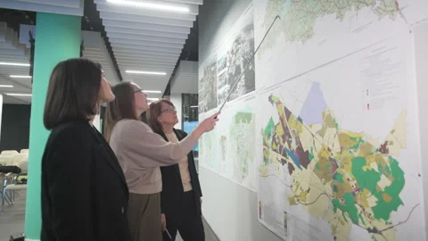 Architect designers study city maps planning development Stock Footage 325994350