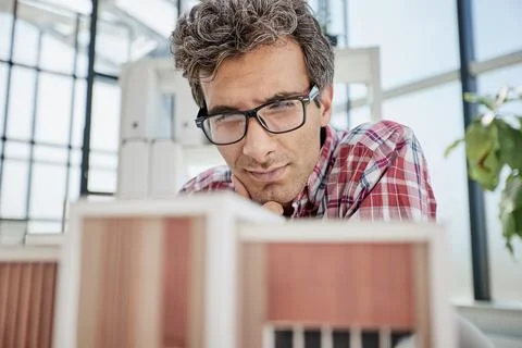 Architect designing and building a model house - generative ai Fotos de archivo
