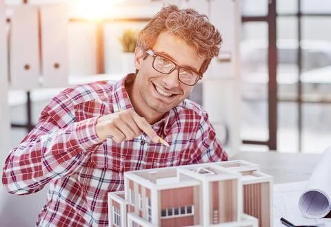 Architect designing and building a model house - generative ai Fotos de archivo