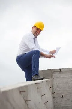Architect designing a building standing on construction site Stock Photos
