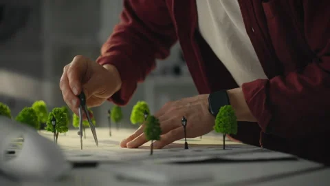 Architect designing a detailed model of a park landscape using precision too Stock Footage 303653496