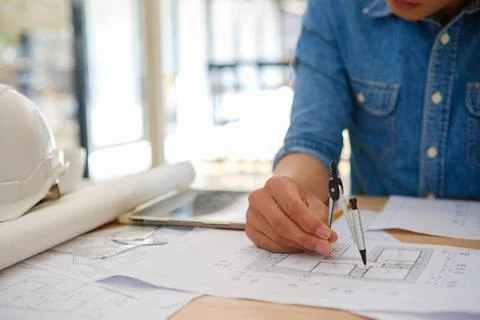 Architect designing house plans using a compass on a work desk in an offic... Stock Photos