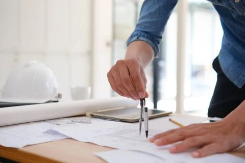 Architect designing house plans using a compass on a work desk in an offic... Stock Photos