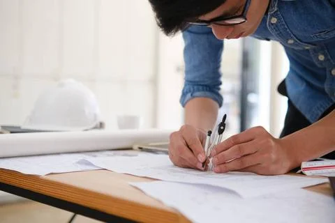 Architect designing house plans using a compass on a work desk in an offic... Stock Photos