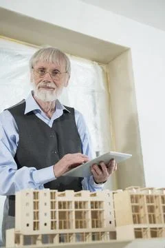 Architect with digital tablet at construction site of new building Fotos de archivo