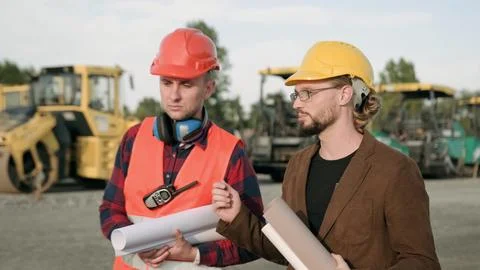 Architect discuss about work process on site with builder Stock Photos