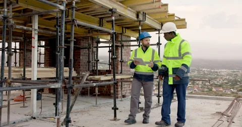 Architect, discussion and men with tablet on construction site, teamwork and Stock Footage 337632350