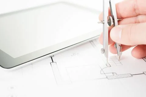 Architect does measuring on a draft. Stock Photos