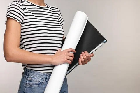 Architect with draft and folder on light grey background, closeup Foto stock