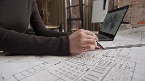 Architect Drafting Floor Plan while Reviewing 3D House Exterior Model Stock Footage 327845907