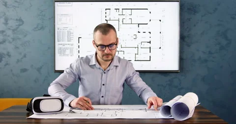 Architect drafts and writes measurements on plan with pencil Video stock 243831702