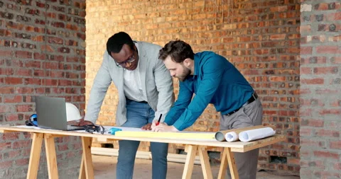 Architect, drawing and men with blueprint in building, talking and planning for Stock Footage 338373563