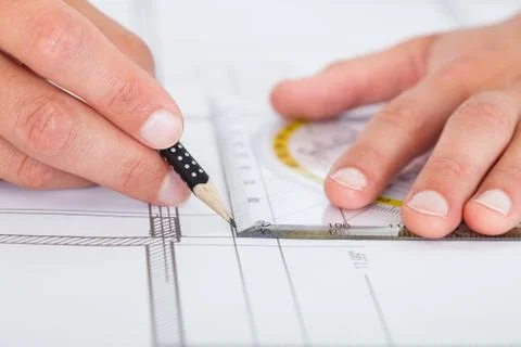 Architect drawing on blueprint Fotos de archivo