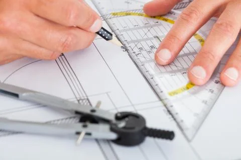 Architect drawing on blueprint Fotos de archivo
