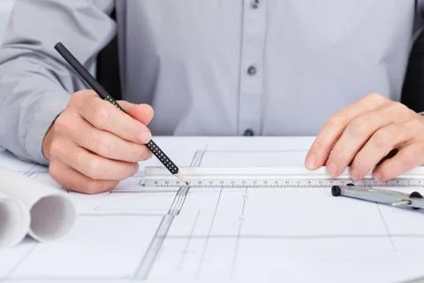 Architect drawing on blueprint Fotos de archivo