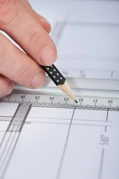 Architect drawing on blueprint Fotos de archivo